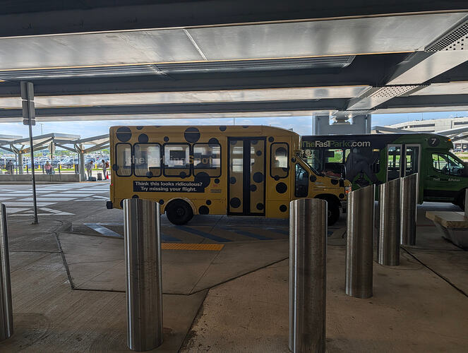 Yellow polka-dot Parking Spot shuttle bus with slogan visible on the side